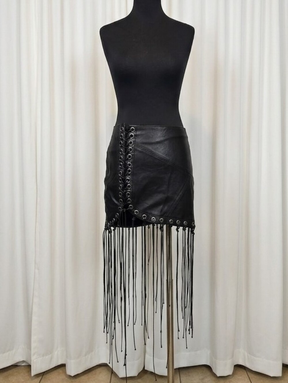 Darker Wavs Faux Leather Lace-Up Mini Skirt with Fringe.